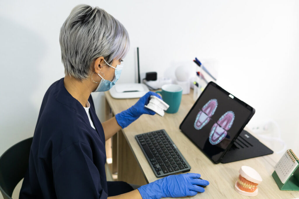 Shallow focus of a female dental technician design - Oral Plastic Surgery & Periodontics